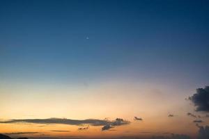 Evening golden hour sky with moon photo