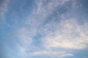 blue sky with clouds and little moon photo