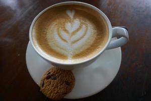 hot latte coffee on wooden table photo