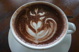 hot latte coffee on wooden table photo