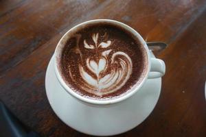 hot latte coffee on wooden table photo