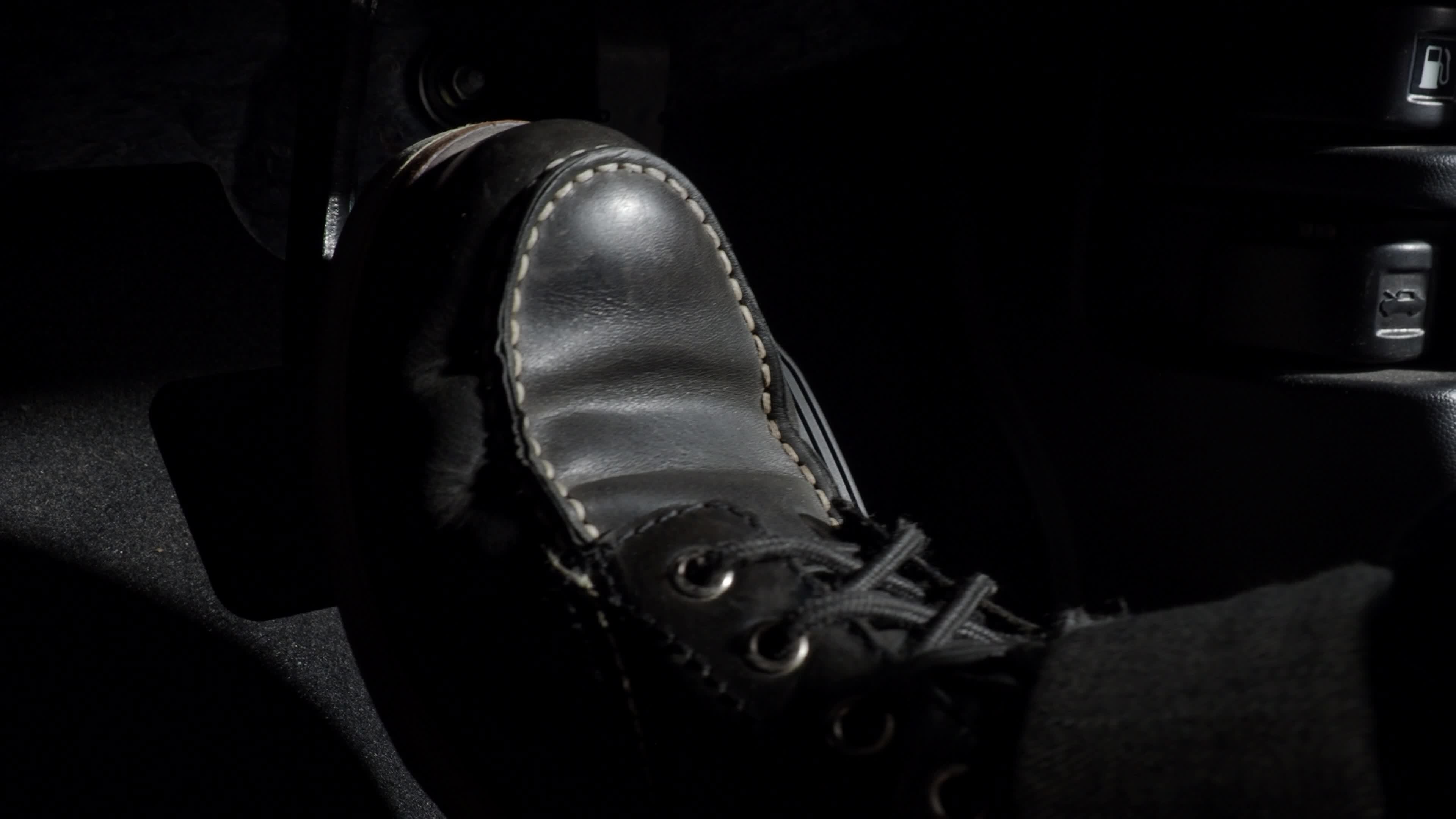 Accelerate and Brake. Foot pressing foot pedal of a car to drive ahead