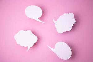 Paper templates in the form of clouds and bubbles for messages on a pink background. photo