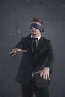 Blind businessman on dark background photo