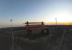 BROKEN HILL, AUSTRALIA. - On December 26, 2019. - The Big Bench of Broken Hill, at 2.5 times the size of a normal park bench this art installation at The Line of Lode with sunset sky. photo