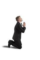 Businessman praying on white background photo