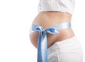 Blue bow on pregnant woman photo