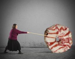 Woman pulling a Giant donut photo