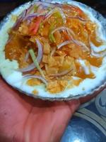 mixed papdi chaat with onion and dahi served in dish isolated on table top view of indian and pakistani food photo