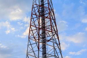 Steel and cable structure of tall telephone poles against beautiful evening blue sky background. photo