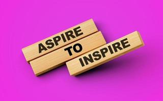 Aspire To Inspire Text On Wooden Blocks Isolated On Magenta Background, 3d illustration photo