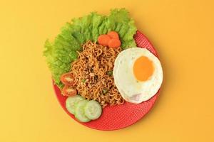 Indomie Goreng. Indonesian Instant Noodle with Sunny Side Egg photo