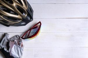 Bicycle accessories on white wooden background with copy space photo