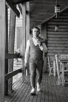 portrait of the groom in a gray suit and an orange vest photo