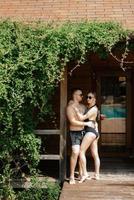 guy and a girl in bathing suits are relaxing, near the blue pool photo