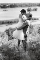 young couple a guy and a girl are walking in the green hills photo