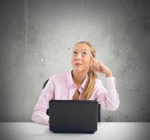 Businesswoman thinking on her desk photo