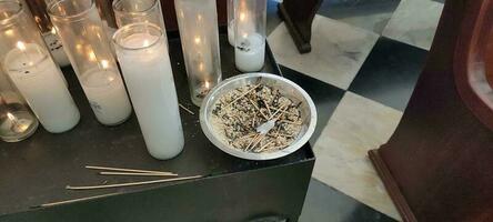 used matches and prayer candles with flames in church photo