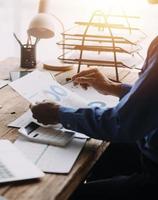 Group of confident business people point to graphs and charts to analyze market data, balance sheet, account, net profit to plan new sales strategies to increase production capacity. photo