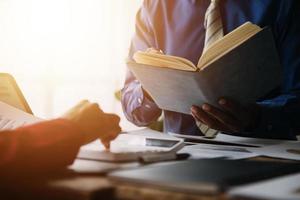 Group of confident business people point to graphs and charts to analyze market data, balance sheet, account, net profit to plan new sales strategies to increase production capacity. photo