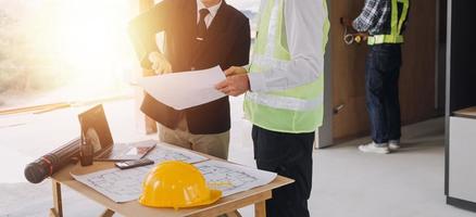 Architect concept, Architects working with blueprints in the office, Vintage Effect photo