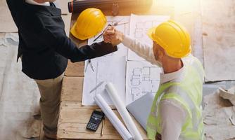 Architect concept, Architects working with blueprints in the office, Vintage Effect photo