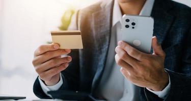 Close up of woman hand using credit card and laptop for payment and online shopping, Online shopping, payments digital banking, E-commerce concept. photo