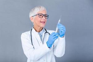 Doctor, researcher or scientist hand in blue glove holding flu, measles, rubella or hpv vaccine and syringe with needle vaccination for baby, child, woman or man shot, medicine vial dose injection photo