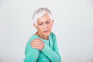 Senior woman with shoulder pain. Elderly woman is enduring awful ache. Shoulder Pain In An Elderly Person. Senior lady with shoulder pain photo