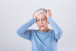 Attack of the monster migraine. Sinus pain. Unhappy Retired Senior Woman holding her head with pain expression . Face of senior woman suffering from headache photo