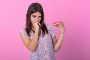 Woman on dieting for good health concept. Close up female using hand push out her favourite donut for good health. Diet, dieting concept. Junk food, Slimming, weight loss photo