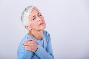 Senior woman with shoulder pain. Elderly woman is enduring awful ache. Shoulder Pain In An Elderly Person. Senior lady with shoulder pain photo