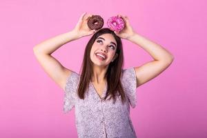 Beauty model girl taking colorful donuts. Funny joyful woman with sweets, dessert. Diet, dieting concept. Junk food, Slimming, weight loss photo