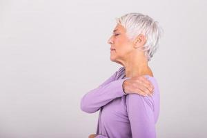 Senior woman with shoulder pain. Elderly woman is enduring awful ache. Shoulder Pain In An Elderly Person. Senior lady with shoulder pain photo