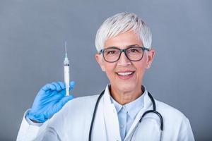 Doctor, researcher or scientist hand in blue glove holding flu, measles, rubella or hpv vaccine and syringe with needle vaccination for baby, child, woman or man shot, medicine vial dose injection photo