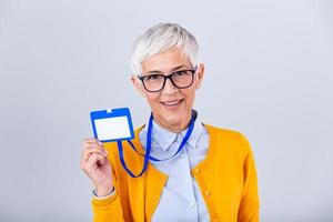 Woman wear blank vertical ID badge mockup, stand isolated. Name tag on neck and chest. Person identity label. Women in shirt uniform with empty id card mock up. Bussinesswoman lanyard design. photo