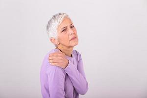 Senior woman with shoulder pain. Elderly woman is enduring awful ache. Shoulder Pain In An Elderly Person. Senior lady with shoulder pain photo