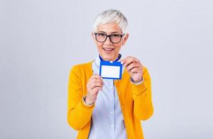 Woman wear blank vertical ID badge mockup, stand isolated. Name tag on neck and chest. Person identity label. Women in shirt uniform with empty id card mock up. Bussinesswoman lanyard design. photo