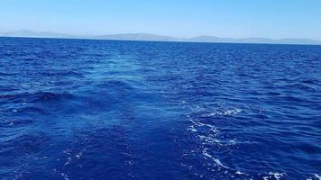 Summer holiday concept. The endless blues of the Aegean. The sun shines brightly and is reflected in the water. Natural sky and horizon background video