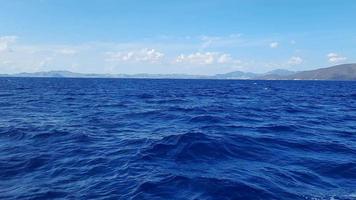 Summer holiday concept. The endless blues of the Aegean. The sun shines brightly and is reflected in the water. Natural sky and horizon background video