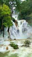 Tat Kuang Si waterfalls is limestone waterfall beautiful and very nice landscape Vertical video