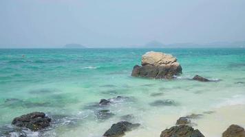 Sea landscape with rocks on the beach Beautiful blue water with waves video