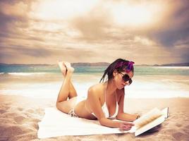 Woman relaxing on the beach photo