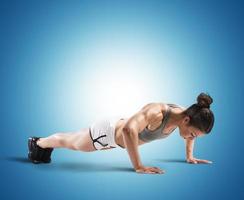 Fitness woman doing push-ups photo