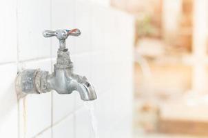 Old rusty water tap in school,Old Water Tap in the Open and Water Drops photo