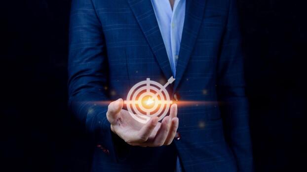 Targeting concept with businessman hand holding digital image of dartboard,Businessman holding virtual dartboard and arrow with copy space for setup business objective target concept. photo