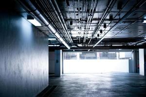 Sanitary system pipes and electrical cables installed under flat slab reinforced concrete structure in building.Ventilation pipes in Underground Parking photo