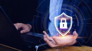 Computer network protection, secure and safe your data concept, businessman holding shield protection icon, Security shield Lock Security Businessman Protect Concept photo