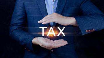 Concept of taxes payment optimisation business finance, Businessman touching taxes icon, income tax and property, Tax Payment, individuals and corporations such as VAT photo