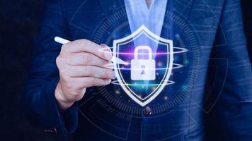 Computer network protection, secure and safe your data concept, businessman holding shield protection icon, Security shield Lock Security Businessman Protect Concept photo